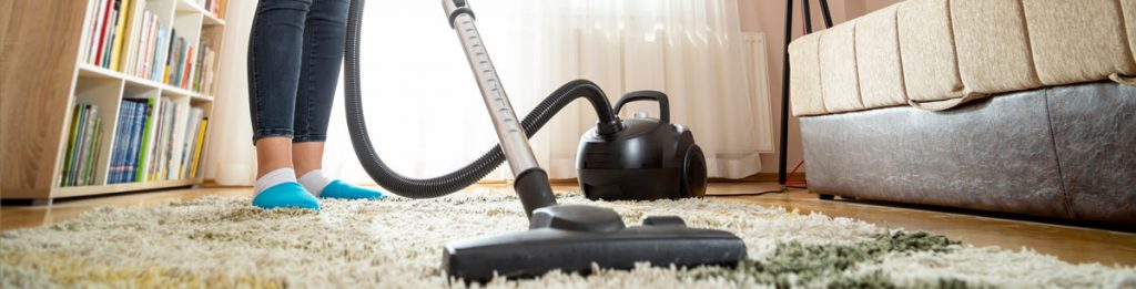 HEPA vacuum cleaning carpet to remove fine lead dust after home renovation