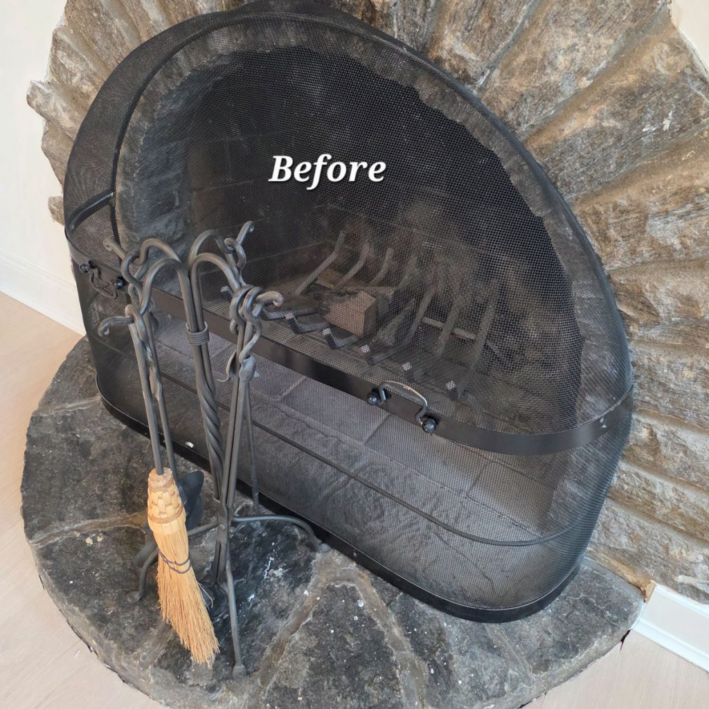 Dust buildup on residential stone fireplace before post-construction dust remediation cleaning