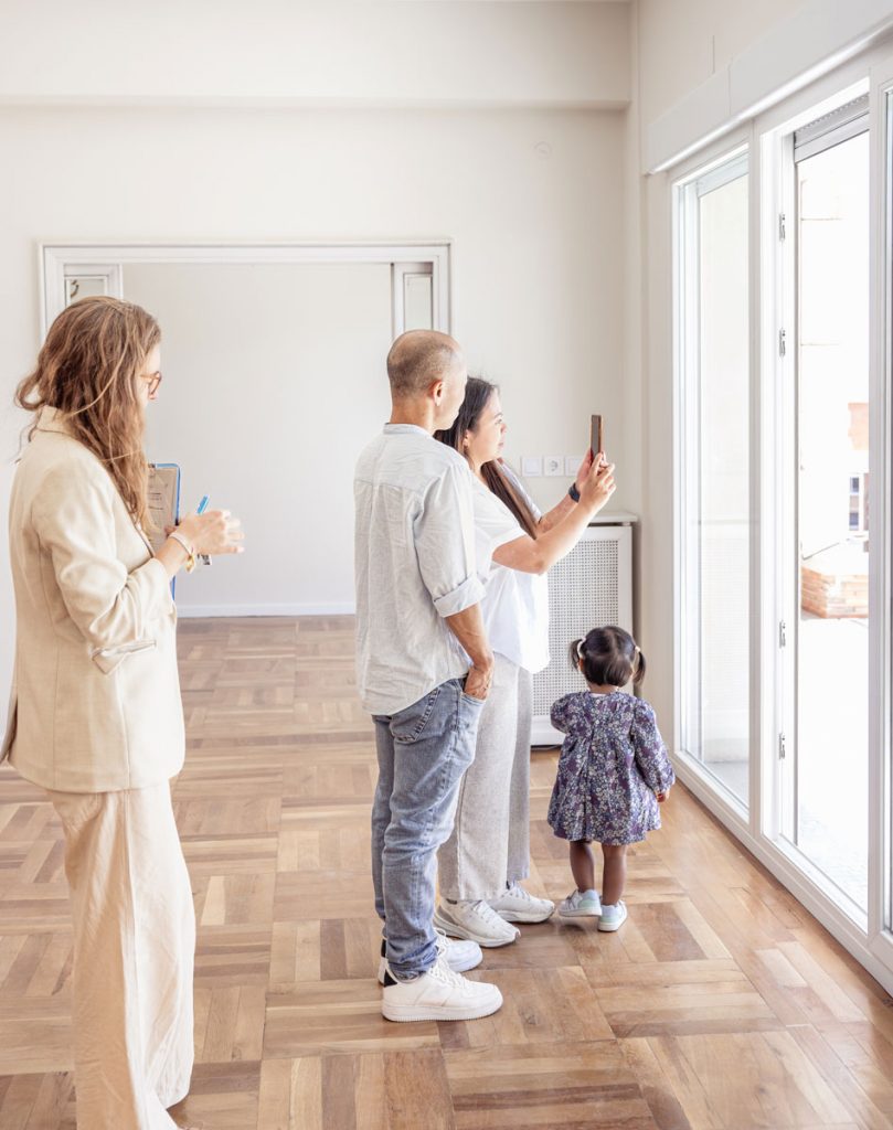 Family inspecting an empty home during a move-out walkthrough before professional cleaning