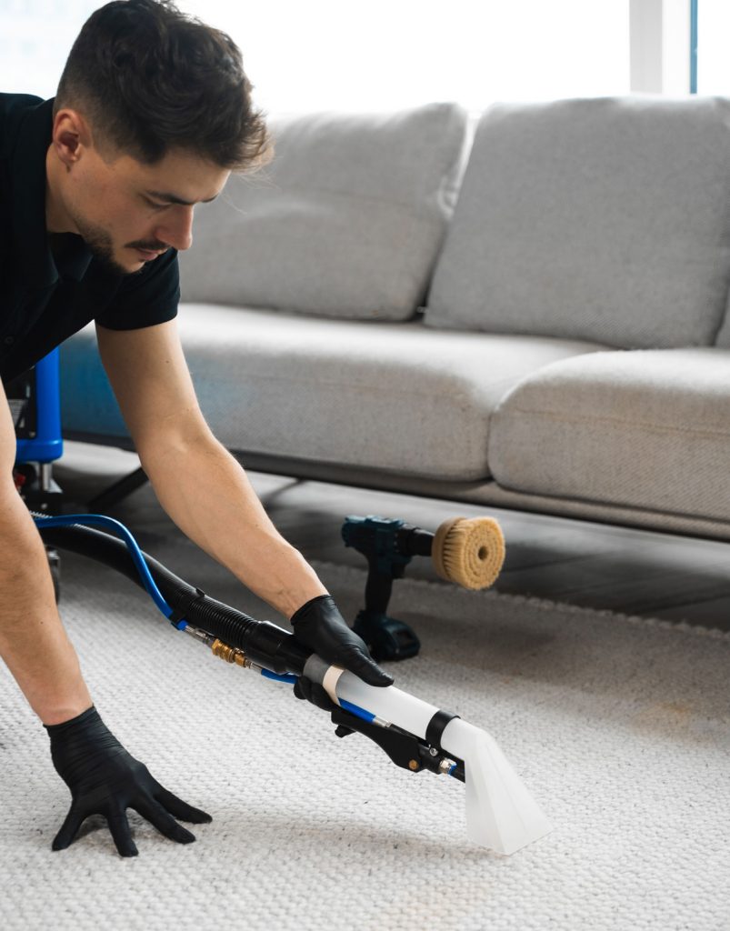 Professional carpet cleaning during post construction cleanup using extraction equipment to remove dust and debris before move-in readiness