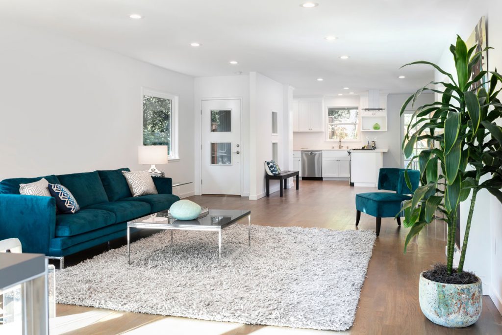 Move-in ready home interior after professional post construction cleaning with detailed surfaces, polished hardwood floors, and completed renovation finishes in open living space
