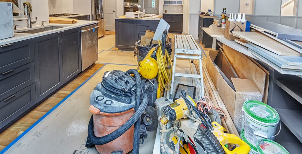 Construction debris and dust left inside a newly renovated kitchen before post-construction cleaning and final cleanup